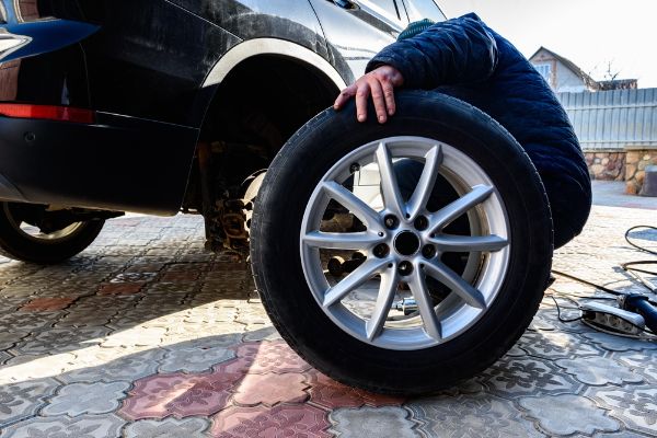 mechanic looking at wheels