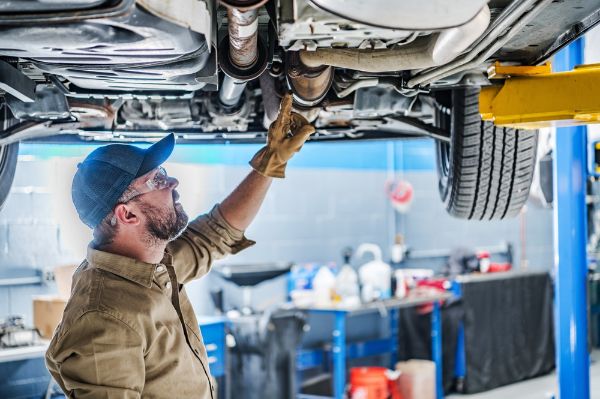 mechanic checking under vehicle