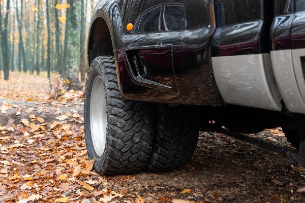 Close-up detail bottom pov view of dual twin offroad performance wheel of heavy duty pickup truck