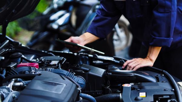 Mechanic conducting a vehicle maintenance inspection