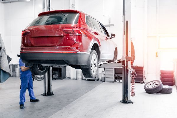 mechanic inspecting wheel
