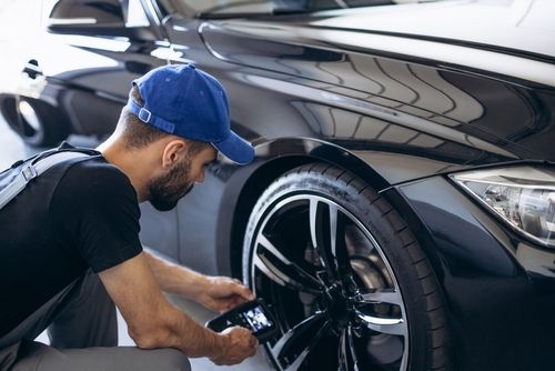 mechanic rotating tires