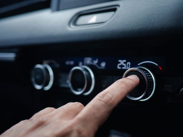 close up of finger turning on AC