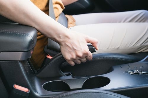 woman pulling emergency brake