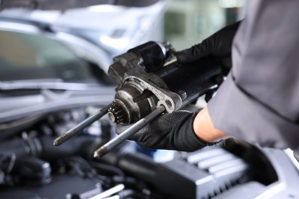 Professional mechanic doing a starter inspection on a vehicle