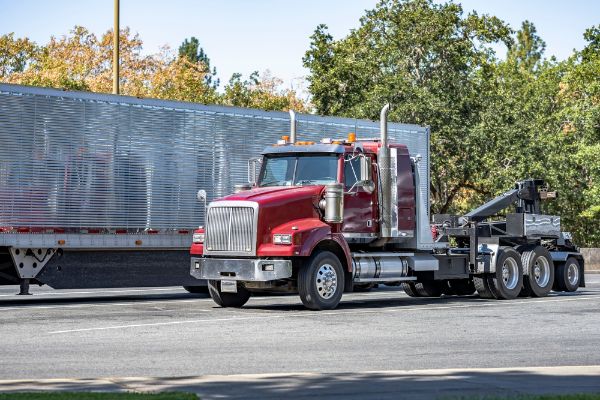 Industrial powerful burgundy road assistant helper mobile heavy duty big rig towing semi truck