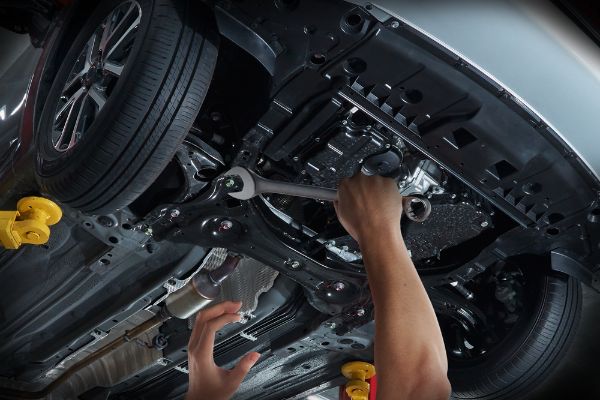 mechanic working on vehicle suspension