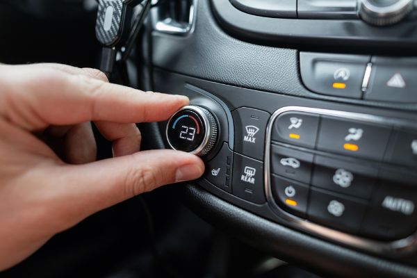 a mechanic testing the heater systems in the vehicle