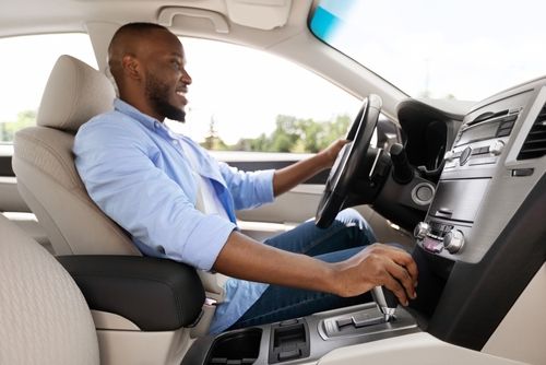 Man enjoying smooth ride with hands on gear shift