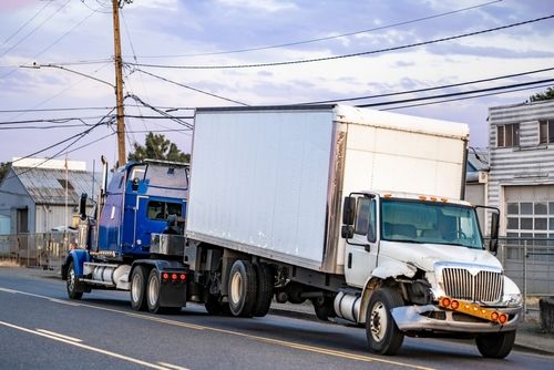 tow truck hauling box truck