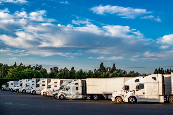ndustrial carriers big rig semi trucks with semi trailers standing for rest in row on the truck stop