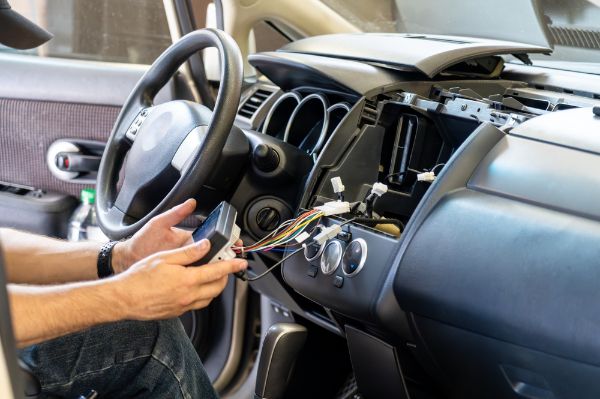 mechanic working on car electrical system