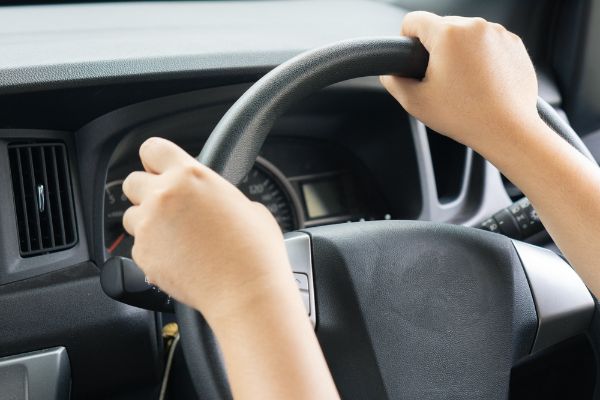 Hand steering wheel car. Pov driving alone