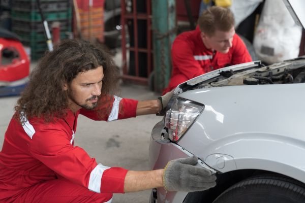 mechanic replacing the front of a car