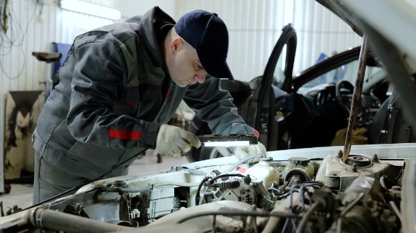mechanic inspecting a vehicles engine