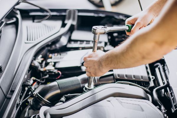 Mechanic performing service on a vehicle