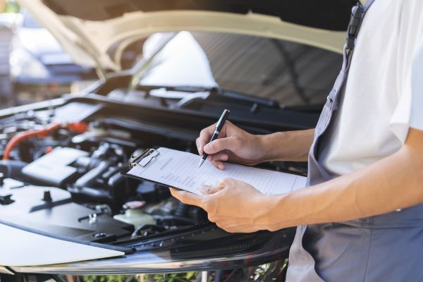 mechanic with maintenance inspection checklist