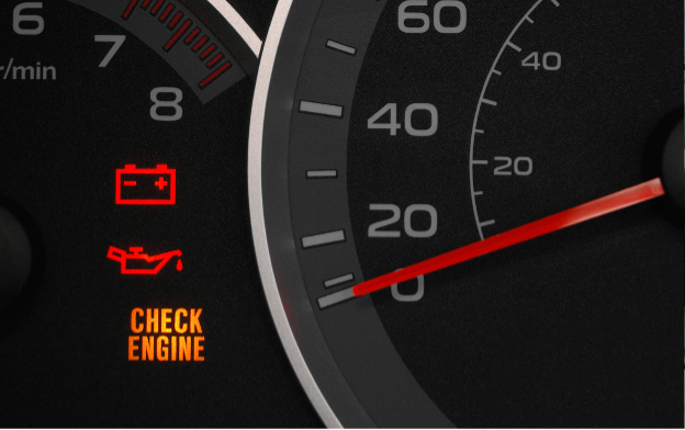 An illuminated check engine light on a car dashboard.