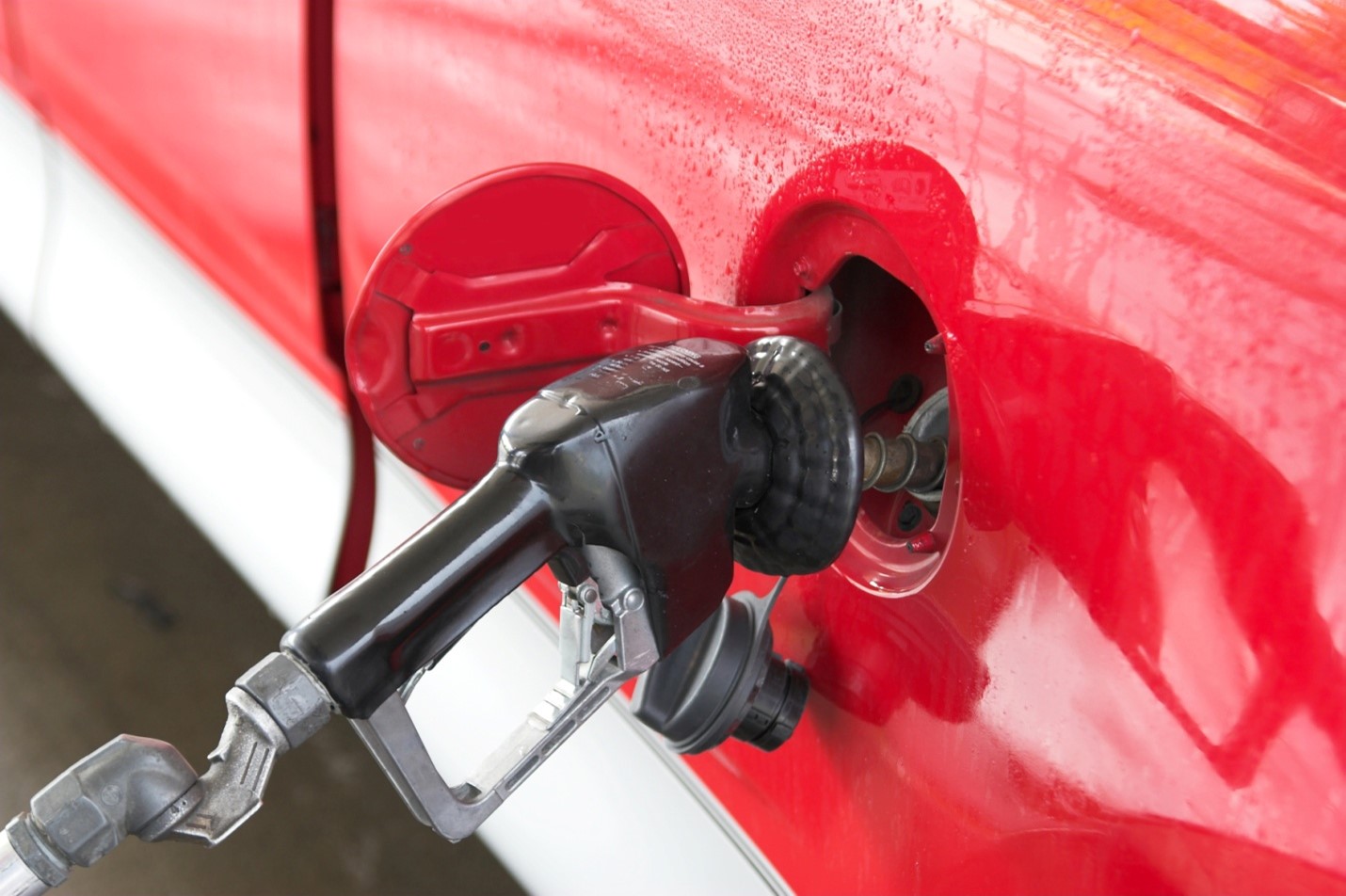 Gas pumping into a red vehicle