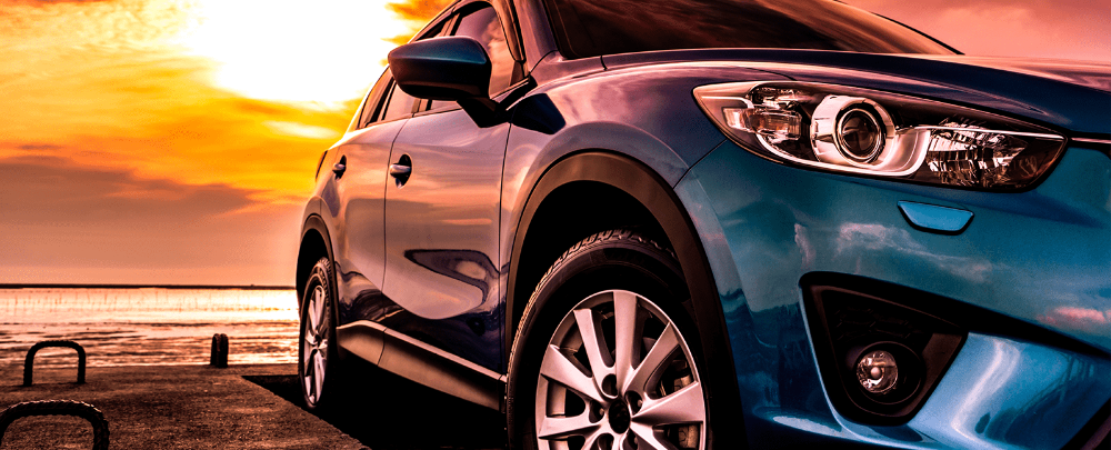 Blue car posing sunset