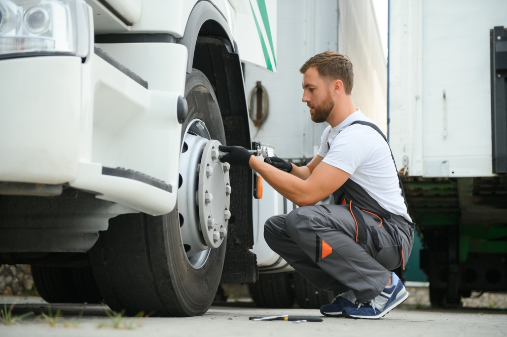 Mechanic replacing hub cap after brake repair