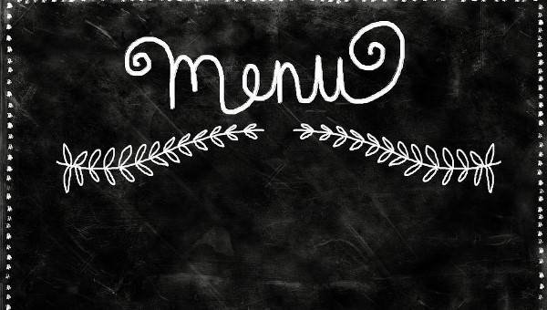 Black menu board with "menu" written on it in chalk and also a couple of plants drawn under it.