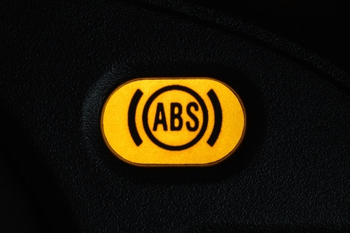 Warning light of the anti-lock braking system -ABS on the dashboard of the car.